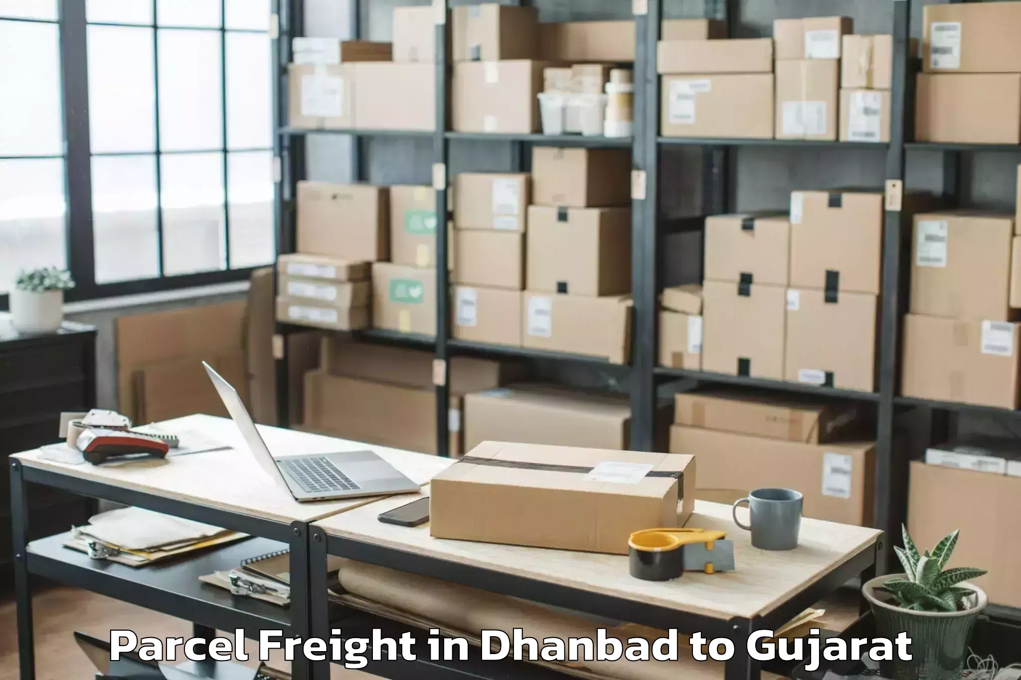 Easy Dhanbad to Rai University Ahmedabad Parcel Freight Booking